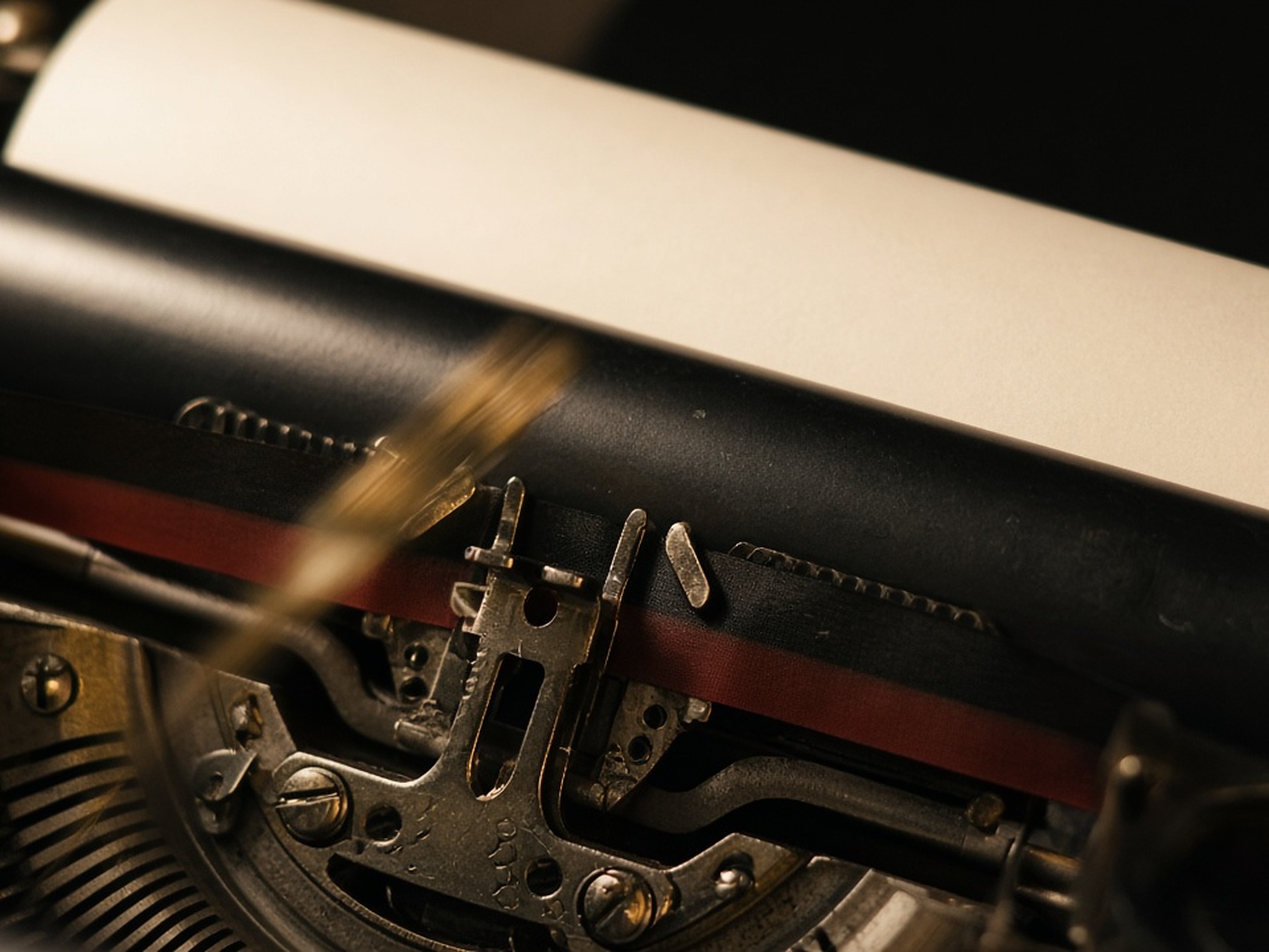 Close-up of a typewriter platen, ribbon, and print point